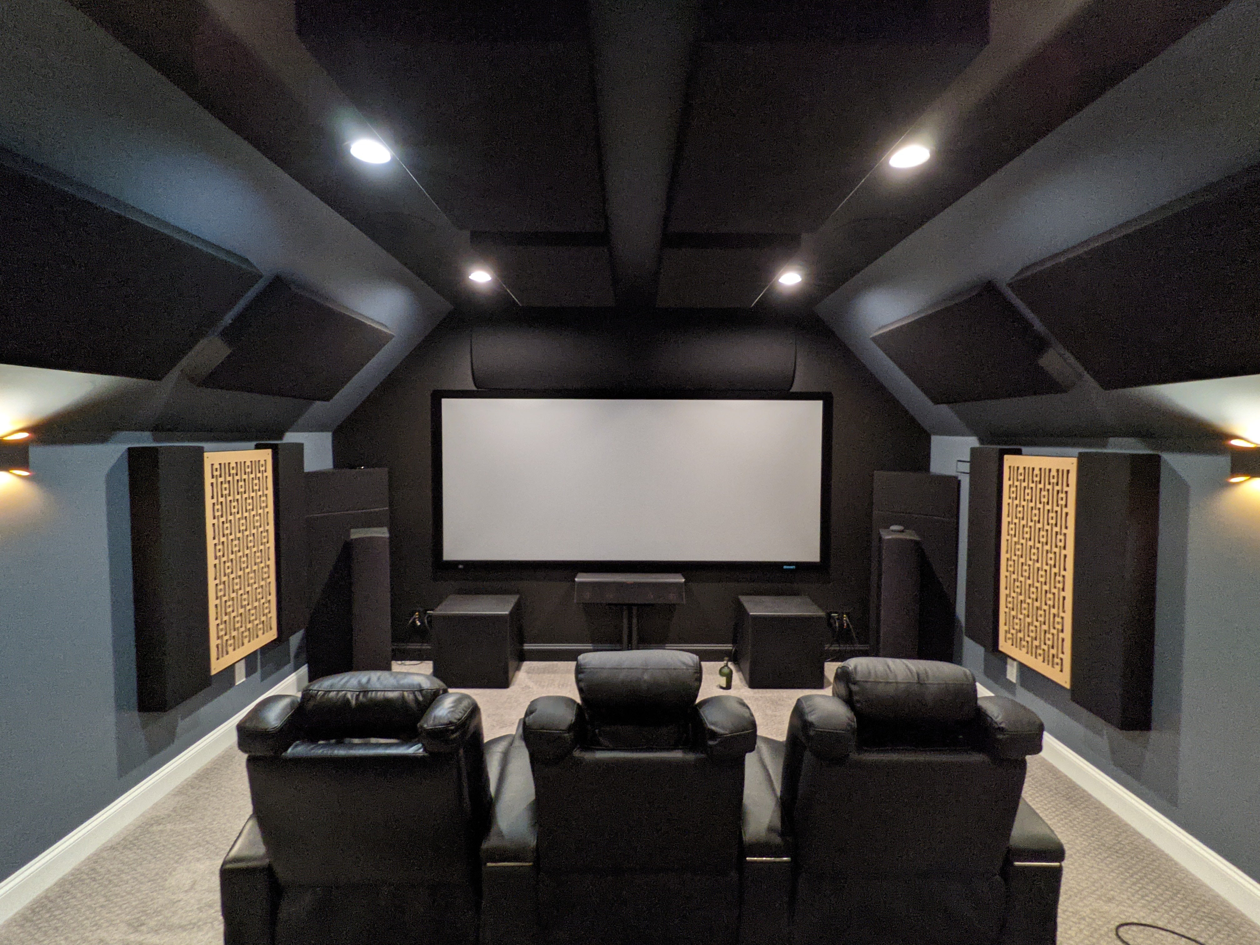 Home theater with projection screen in front with GIK Amplitude and FlexRange Panels on the walls and ceilings