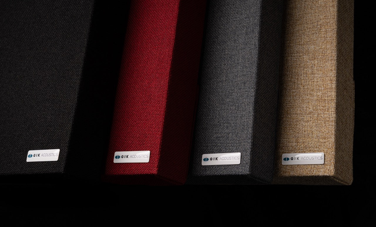 GIK Acoustics Classic Acoustic Panels shown in four fabric colours — black, red, charcoal, and natural — fanned out against a dark background.