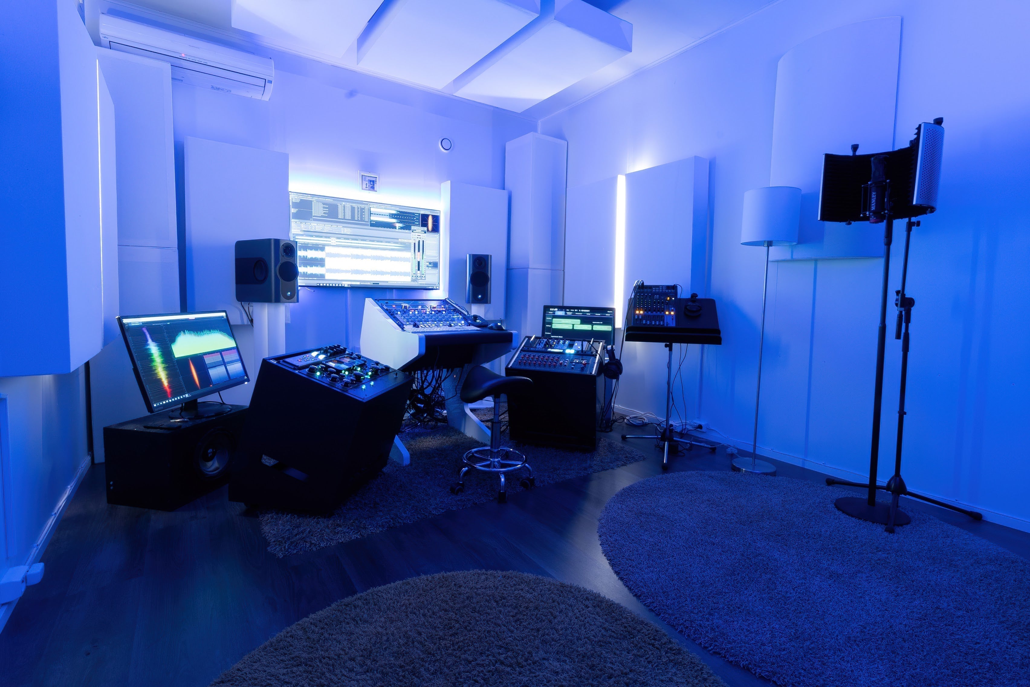 Dark and Moody photo of a studio mixing position with light colored panels