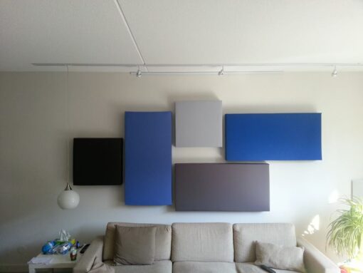 GIK Acoustics 242 Acoustic Panels in different colors and shapes above a couch