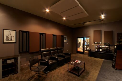Listening room with large speakers, acoustic panels, and a colorful tapestry on the wall.