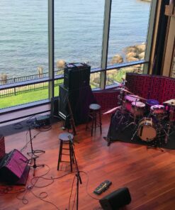 Impression Pro Series Bass Traps standing behind drumset and amplifier with view of water