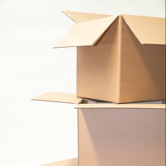 Stack of open cardboard boxes against a plain white background.